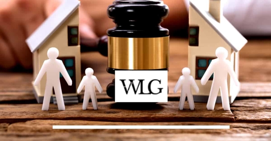 Close up hourglass measuring time, standing on wooden office table.