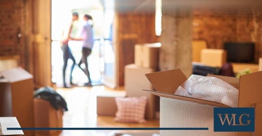 Couple standing outside and boxes.