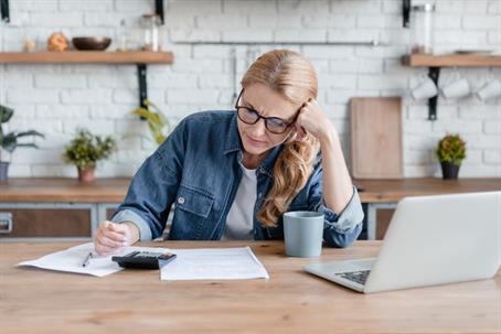 stressed woman doing her finances at home