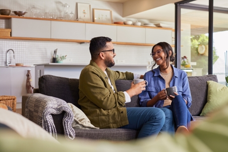 happy couple talking and drinking coffee