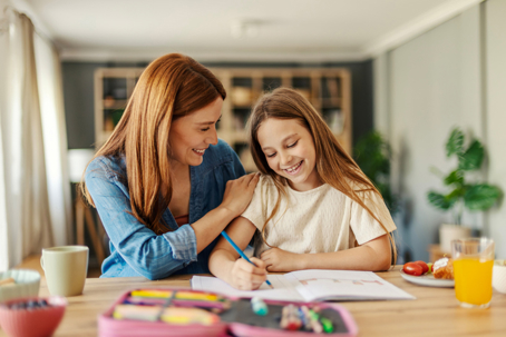 mother helping daughter with homework