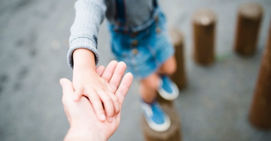 son holding parents hand