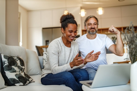 Parents talking with their children, looking very proud.